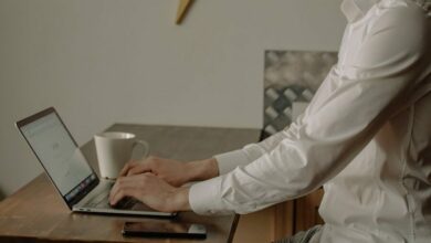 Man in White Dress Shirt Using Black Laptop Computer