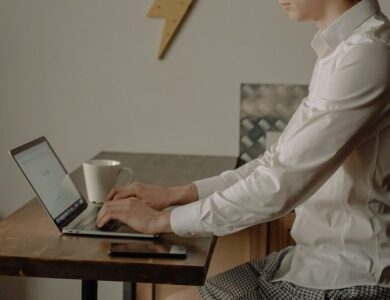 Man in White Dress Shirt Using Black Laptop Computer
