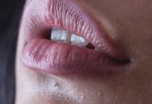 person with red lipstick and black mascara