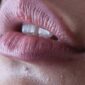 person with red lipstick and black mascara