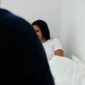 woman lying on bed in room
