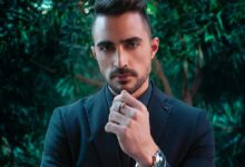 man in black suit jacket wearing silver ring