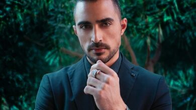 man in black suit jacket wearing silver ring