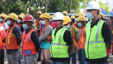 group of people wearing orange hard hat and backpacks
