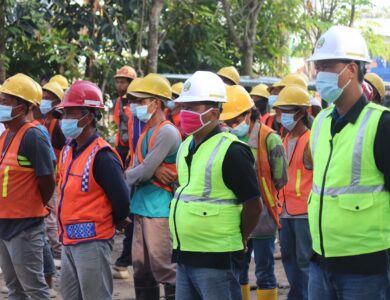 group of people wearing orange hard hat and backpacks