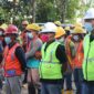 group of people wearing orange hard hat and backpacks