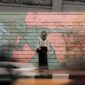 woman standing against mural wall