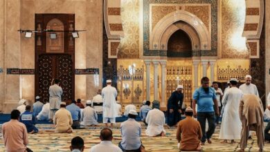 men kneeling and bowing inside building