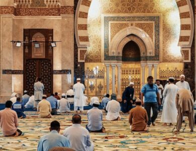men kneeling and bowing inside building