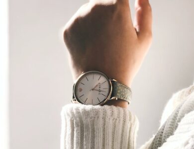 person wearing round silver-colored analog watch