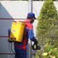 woman in blue and red jacket holding yellow plastic bucket