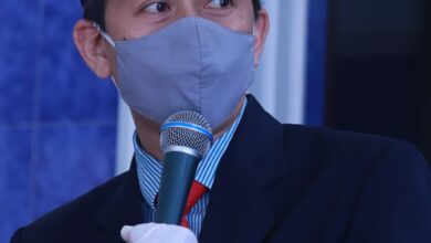 man in black suit jacket holding microphone
