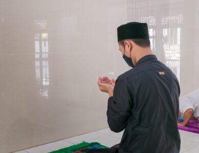 man in black long sleeve shirt holding white smartphone