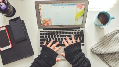 person in black long sleeve shirt using macbook pro