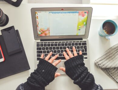 person in black long sleeve shirt using macbook pro