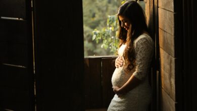 pregnant woman holding her womb