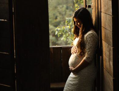 pregnant woman holding her womb