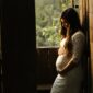 pregnant woman holding her womb