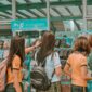 woman in white t-shirt standing in front of woman in yellow t-shirt