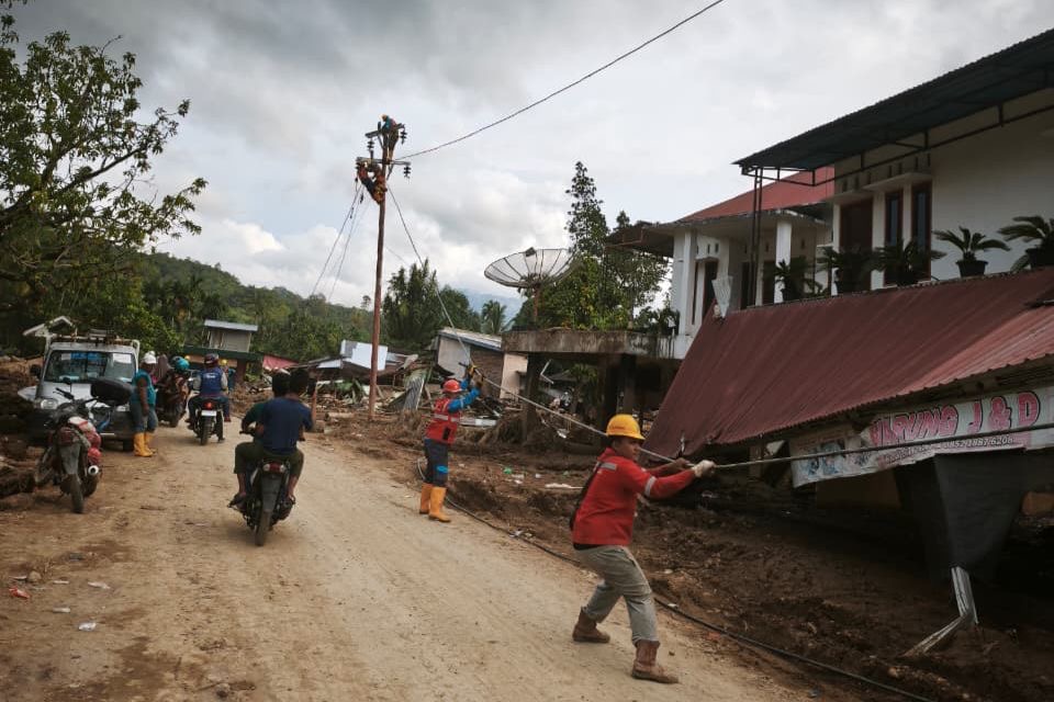 Petugas PLN melakukan penarikan kabel untuk disambungkan ke tiang-tiang listrik jaringan tegangan rendah (JTR) baru di Kabupaten Agam. Total lebih dari 600 tiang listrik pengganti berhasil dipasang oleh Petugas PLN guna memastikan suplai listrik kepada masyarakat kembali normal.