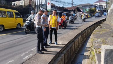 Petugas kepolisian dan pihak terkait meninjau saluran drainase terbuka di Jalan Raya Cipanas–Cianjur, Desa Cipendawa, Kecamatan Pacet, yang menjadi lokasi pasutri asal Bandung hanyut terbawa arus banjir saat hujan deras melanda wilayah tersebut. Foto: Rendi/Cianjur Update